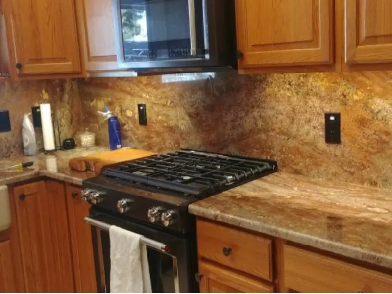Under-cabinet lights over a granite counter and range